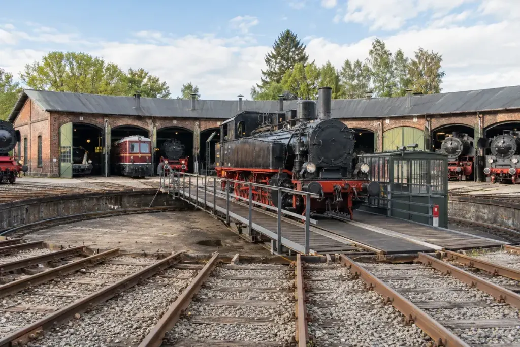 Preserved railway turntable and radial track in a museum yard.